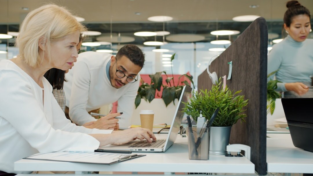 Team of coworkers smiling together in a bright modern office